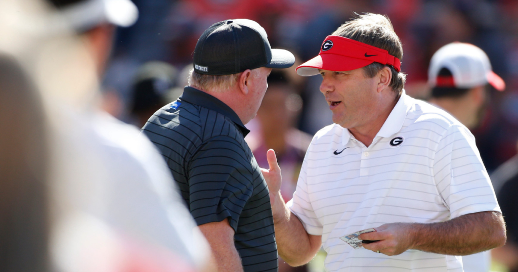 Georgia coach Kirby Smart speaks with Kentucky coach Mark Stoops before an NCAA college football game between Kentucky and Georgia in Athens, Ga., on Saturday, Oct. 16, 2021.
