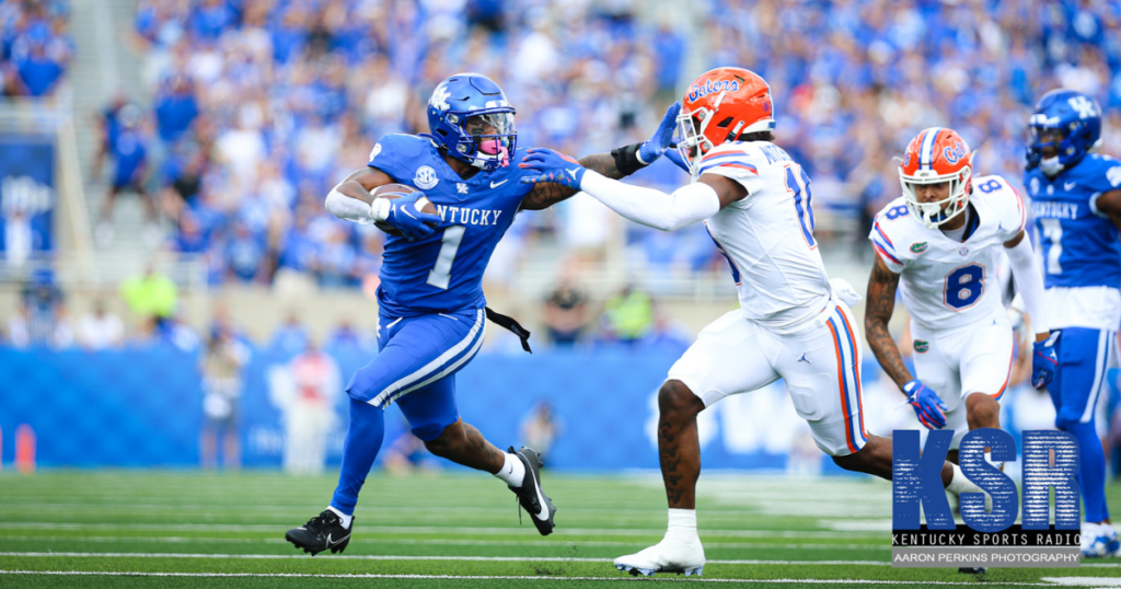 Kentucky running back Ray Davis (left) stiff arms a Florida defender