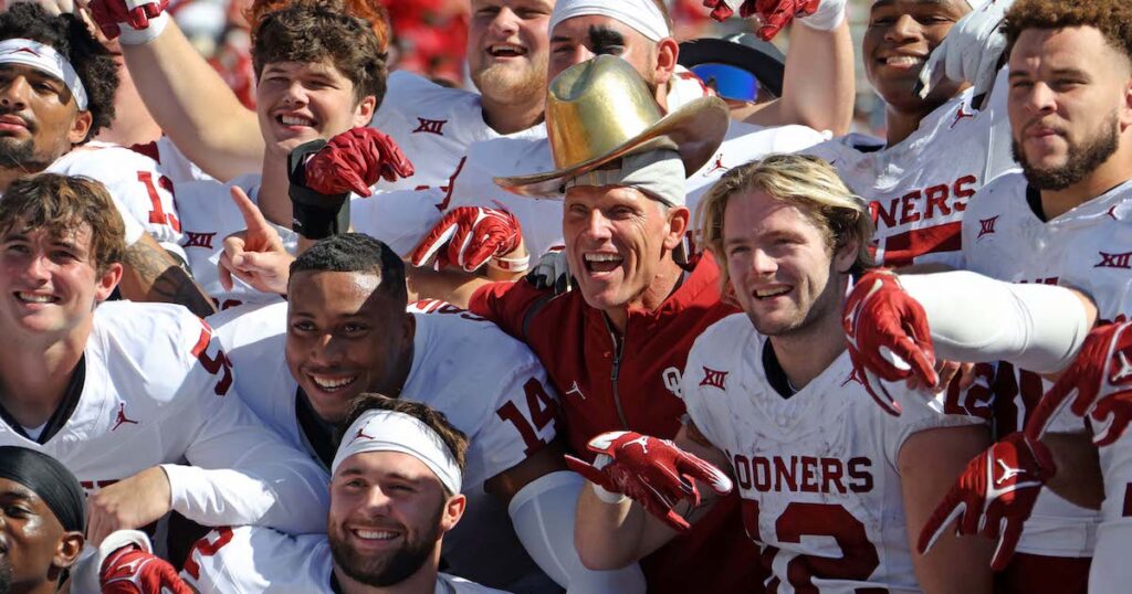 Oklahoma coach Brent Venables poses for a photo wearing the Golden Hat trophy 