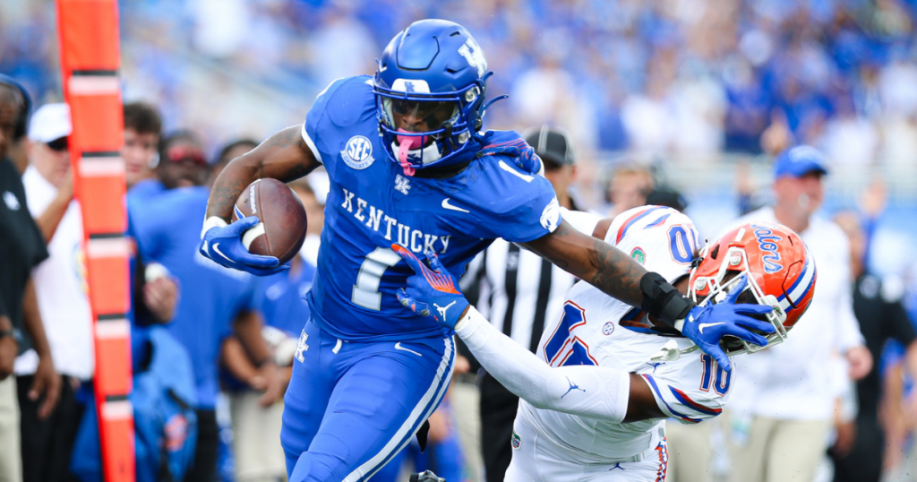 Kentucky running back Ray Davis stiff arms a Florida defender