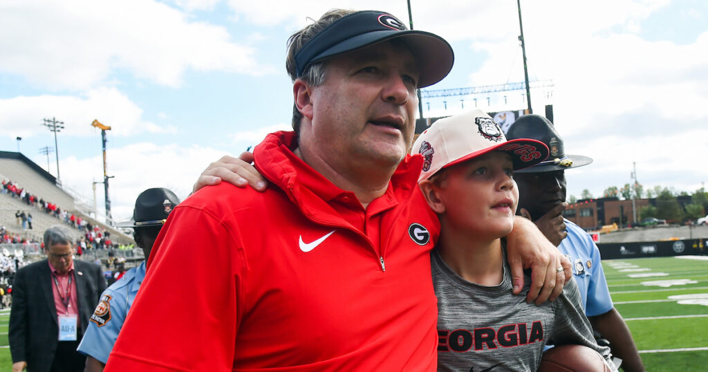 Georgia Bulldogs head coach Kirby Smart leaves the field with his son Andrew