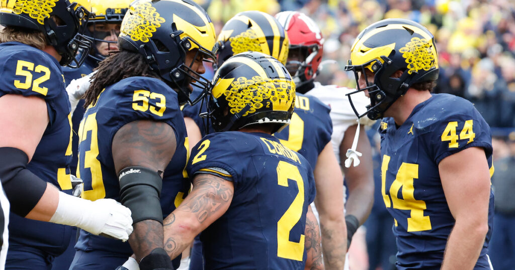 Michigan Wolverines running back Blake Corum receives congratulations from teammates