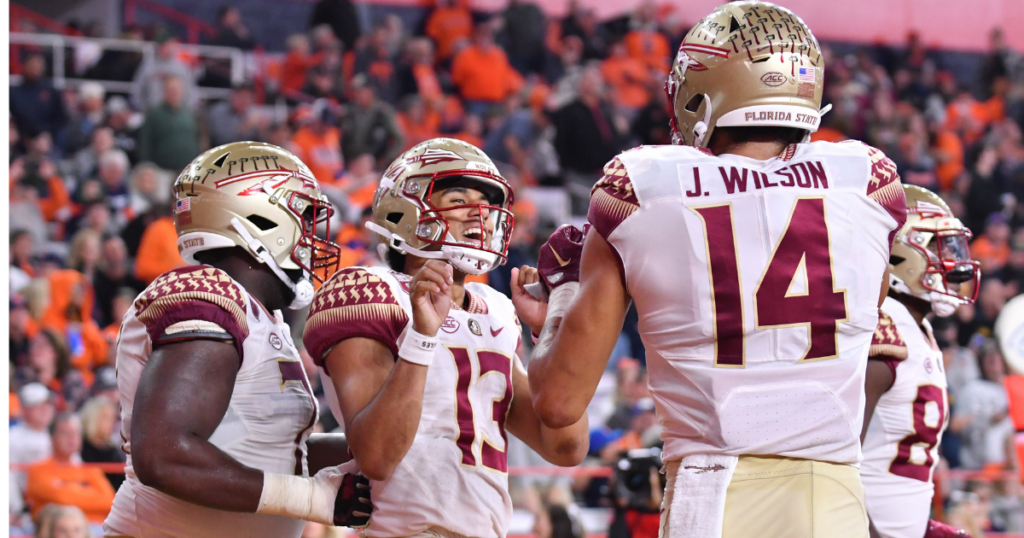 Nov 12, 2022; Syracuse, New York, USA; Florida State Seminoles quarterback Jordan Travis (13) celebrates catching a touchdown pass with wide receiver Johnny Wilson (14) in the third quarter against the Syracuse Orange at JMA Wireless Dome.