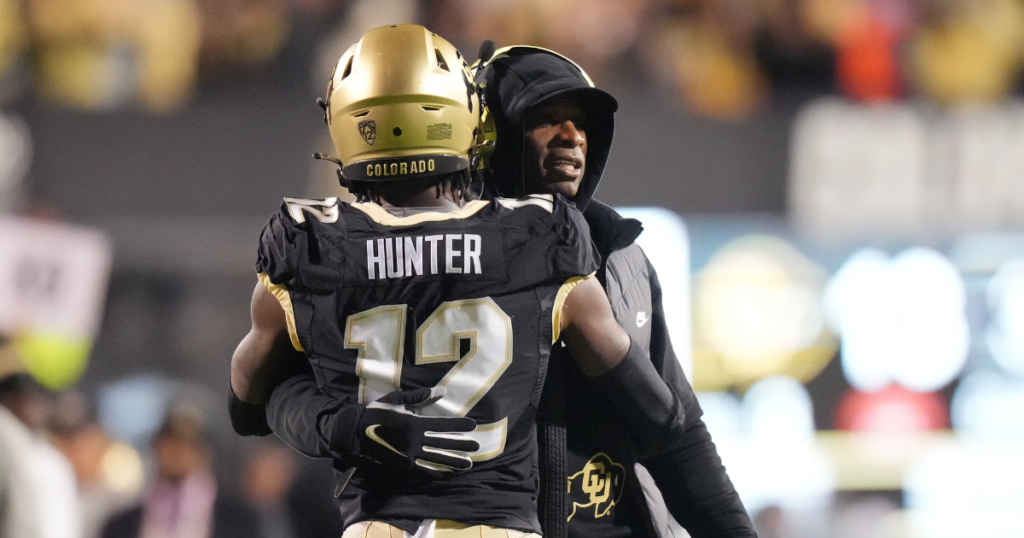 Oct 13, 2023; Boulder, Colorado, USA; Colorado Buffaloes wide receiver Travis Hunter (12) is congratulated for his touchdown by head coach Deion Sanders in the first quarter against the Stanford Cardinal at Folsom Field.