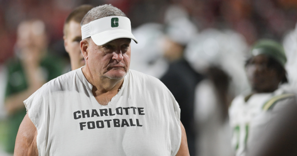 Sep 9, 2023; College Park, Maryland, USA; Charlotte 49ers head coach Biff Poggi walks the sidelines during the first half against the Maryland Terrapins at SECU Stadium.