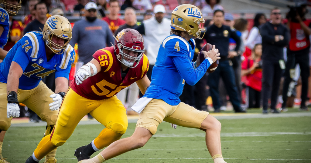 USC defensive lineman Elijah Hughes attempts to tackle UCLA quarterback Ethan Garbers