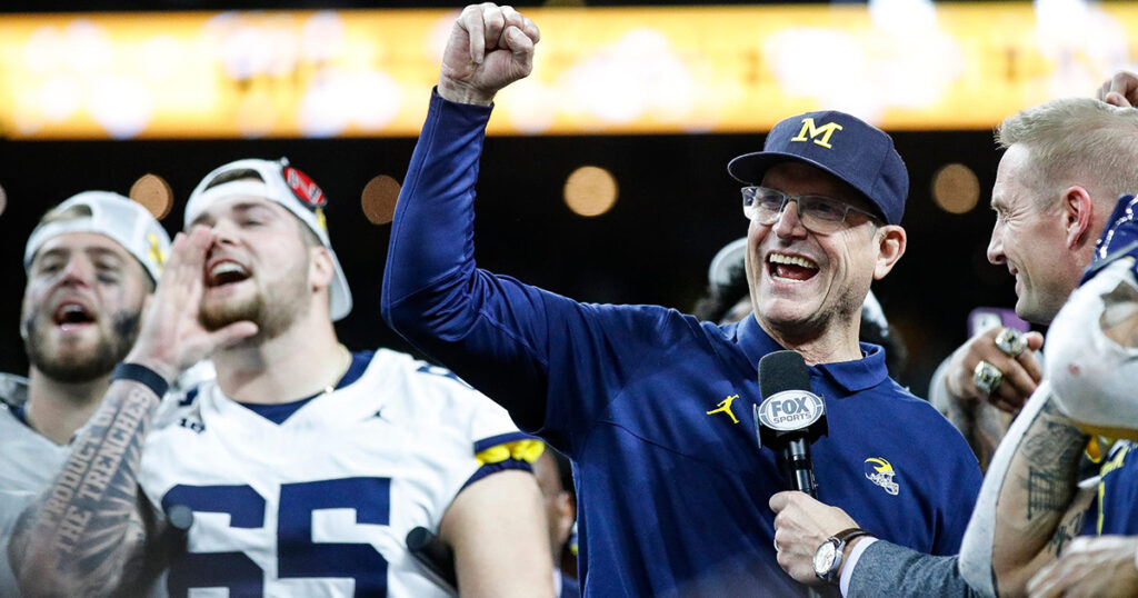 Michigan head coach Jim Harbaugh celebrates the Big Ten Championship