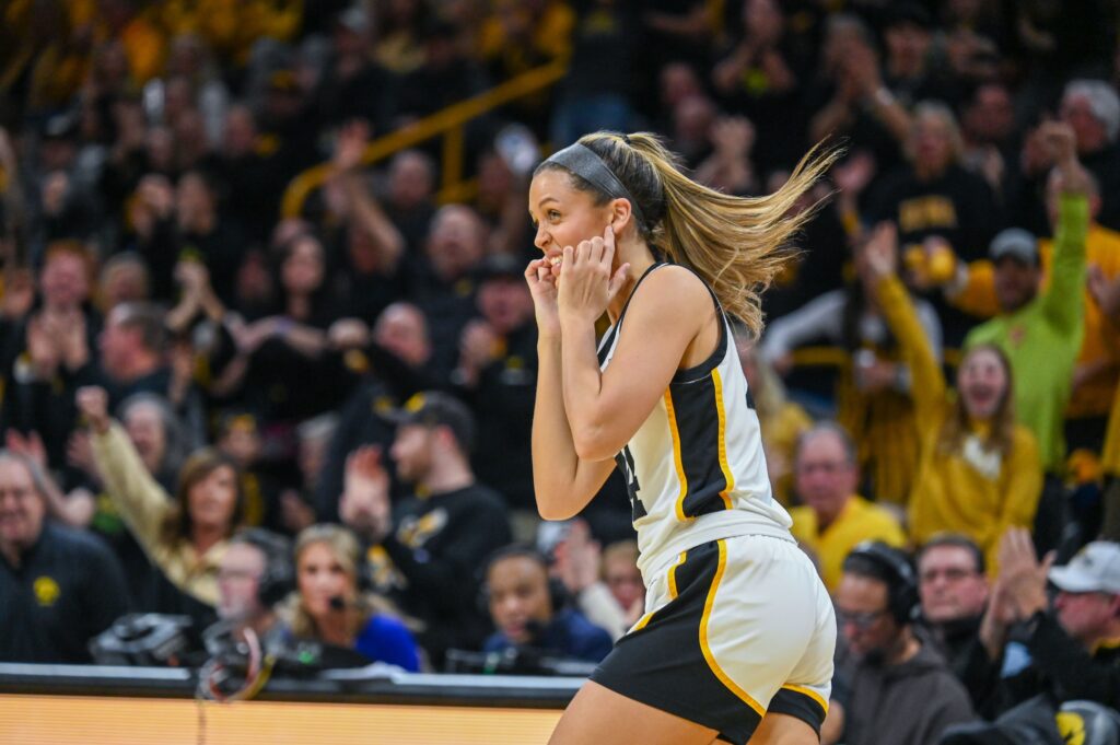 Gabbie Marshall plugs her ears after making a three-pointer