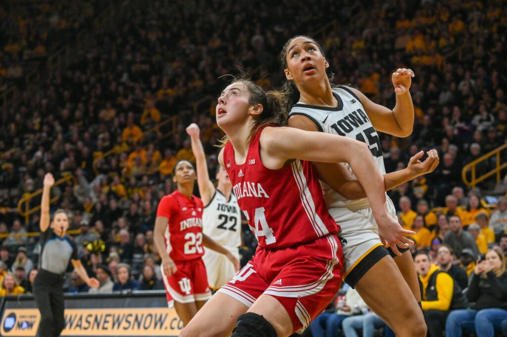 Hannah Stuelke and Mackenzie Holmes battle for a rebound