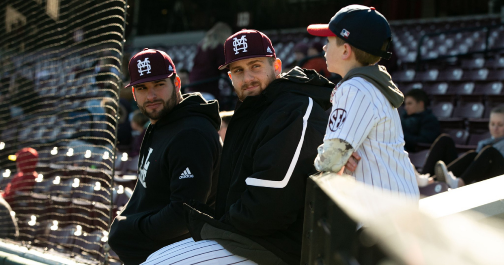 Mississippi State pitchers Preston Johnson and Stone SImmons talk with a young fan.