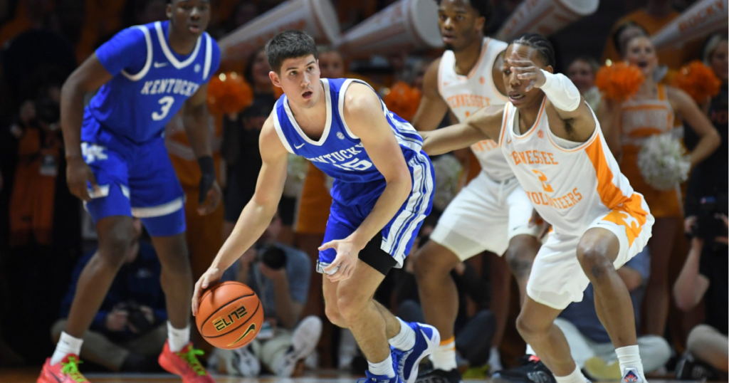 Kentucky guard Reed Sheppard (15) dribbles the ball while defended by Tennessee guard Jordan Gainey (2) during an NCAA college basketball game between Tennessee and Kentucky in Knoxville, Tenn.