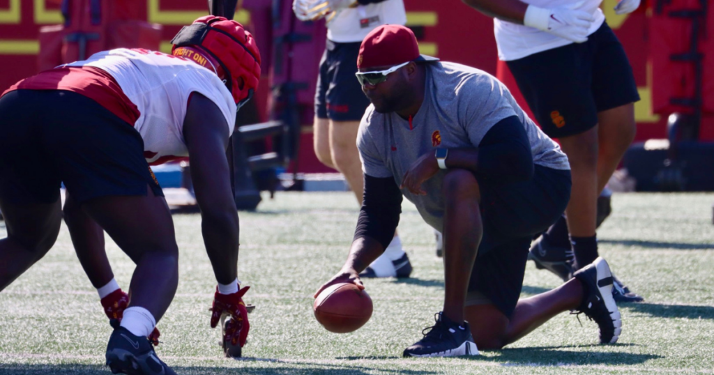 USC defensive line coach Eric Henderson runs a drill during practice with the Trojans