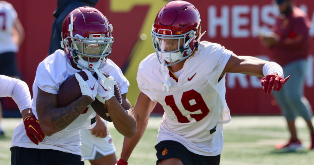 USC cornerback John Humphrey punches at the ball during a practice with the Trojans