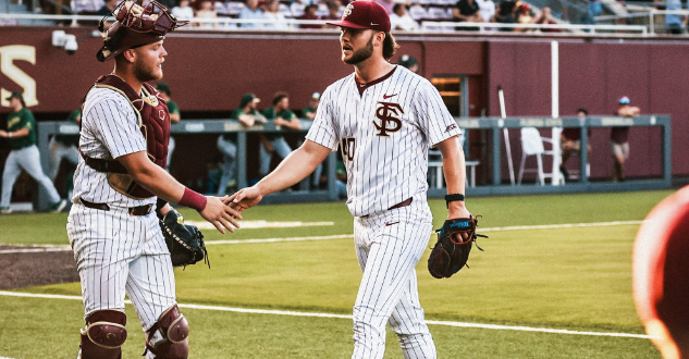 Florida State catcher McGwire Holbrook greets pitcher Joe Charles during Tuesday's game against Jacksonville. (Courtesy of FSU Sports Information)