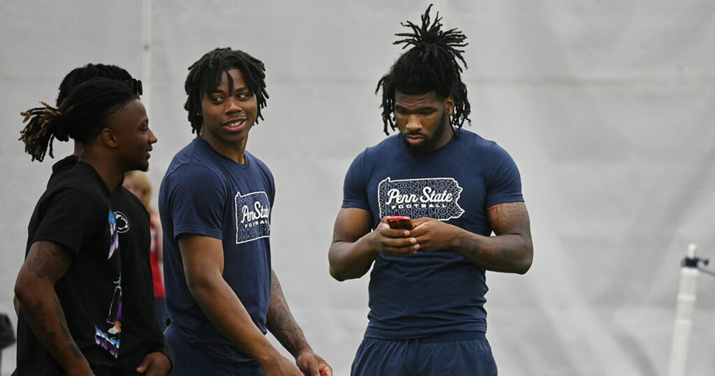 Penn State defensive end Jameial Lyons (right) supporting his former team, Roman Catholic. He's joined by freshman Dejaun Lane (left)and others. (Photo: Thomas Frank Carr/BWI) 