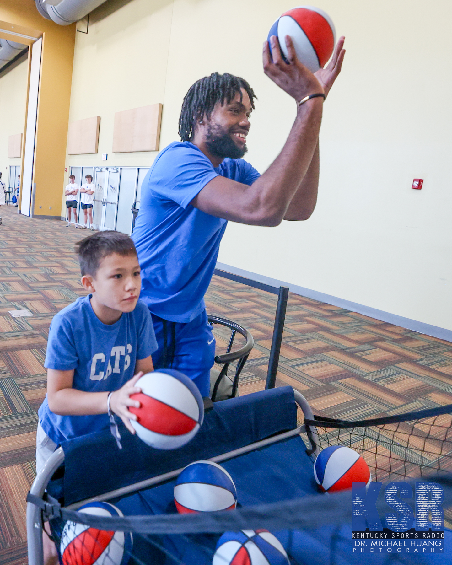 Ansley Almonor plays basketball with a fan at Kentucky Basketball's Club Blue NIL event - Dr. Michael Huang, Kentucky Sports Radio