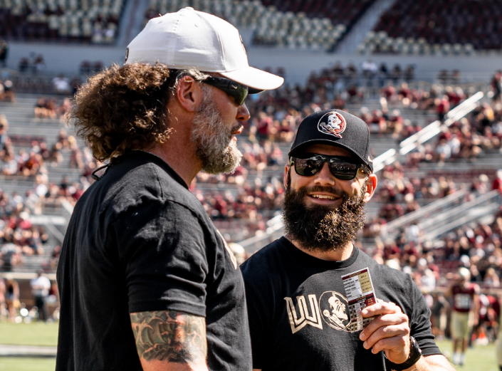 Strength coaches Nick Dowdy (right) and Josh Storms talk before a Florida State game. (FSU Athletics Public Relations/Bella De Souza)