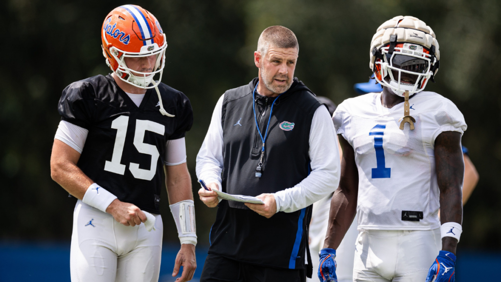 Florida Gators head coach Billy Napier talks with Florida Gators quarterback Graham Mertz (15) and Florida Gators running back Montrell Johnson Jr. (1) during fall football practice at Heavener Football Complex at the University of Florida in Gainesville, FL on Thursday, August 1, 2024. [Matt Pendleton/Gainesville Sun]