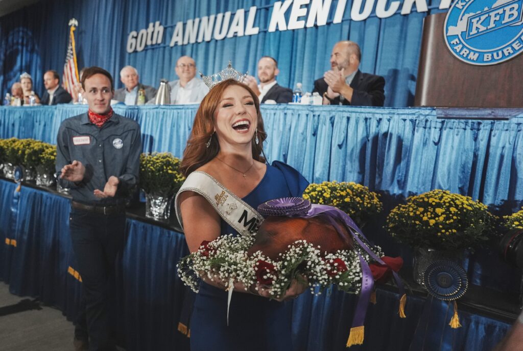 Miss Kentucky's Chapel Tinius laughs while carrying the Grand Champion ham during bidding at the 60th annual Kentucky State Fair Ham Auction Thursday morning, August 22, 2024 - © Matt Stone/The Louisville Courier Journal / USA TODAY NETWORK