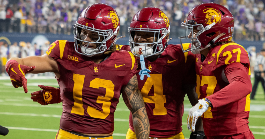 USC Trojans defenders Mason Cobb, Easton Mascarenas-Arnold and Bryson Shaw celebrate Cobb's interception to seal a win against LSU