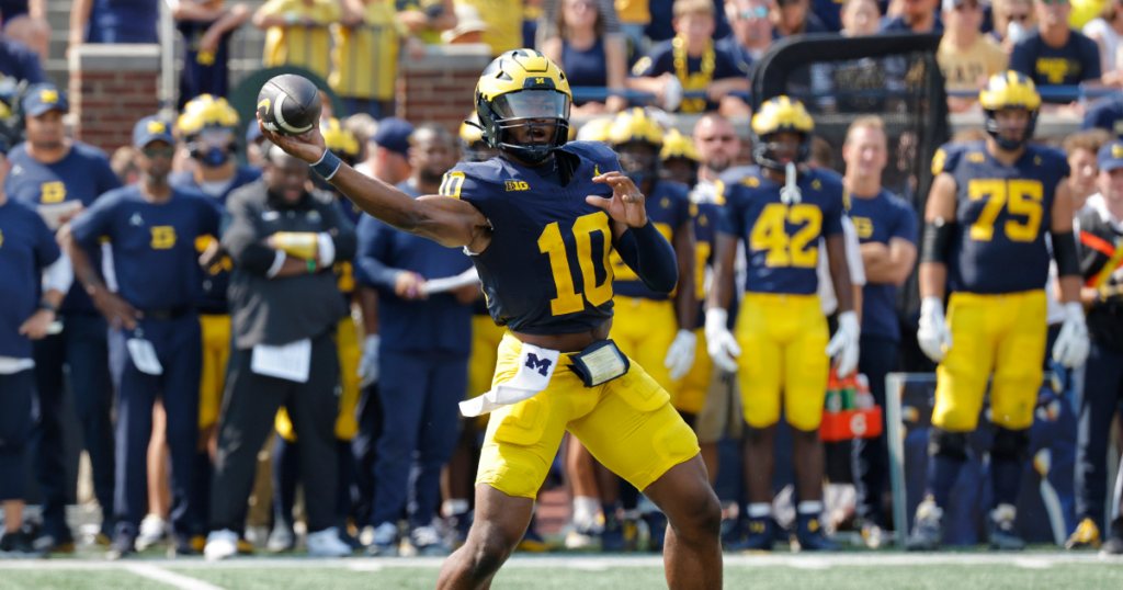 Michigan Wolverines football quarterback Alex Orji threw a touchdown pass against Arkansas State. (Photo by Rick Osentoski-Imagn Images)