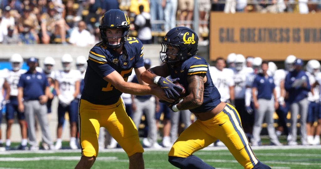 Aug 31, 2024; Berkeley, California, USA; California Golden Bears quarterback Fernando Mendoza (15) hands off to running back Jaydn Ott (1) during the first quarter against the UC Davis Aggies at California Memorial Stadium. Mandatory Credit: Darren Yamashita-Imagn Images