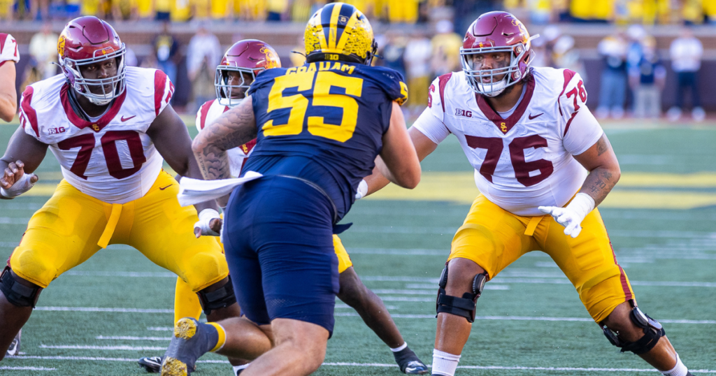 USC offensive linemen Emmanuel Pregnon and Mason Murphy look to block Michigan defensive tackle Mason Graham during a game between the Trojans and Wolverines(acscottphotography/WeAreSC)