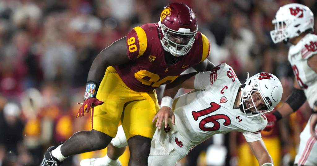 USC Trojans defensive lineman Bear Alexander (90) collides with Utah Utes quarterback Bryson Barnes (16) in the second half at United Airlines Field at Los Angeles Memorial Coliseum