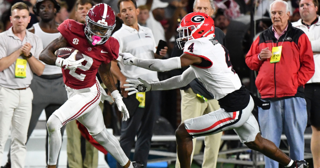 Sep 28, 2024; Tuscaloosa, Alabama, USA; Alabama Crimson Tide wide receiver Ryan Williams (2) breaks a tackle by Georgia Bulldogs defensive back KJ Bolden (4) to score a touchdown that put Alabama ahead in the fourth quarter at Bryant-Denny Stadium. Alabama defeated Georgia 41-34. Mandatory Credit: Gary Cosby Jr.-Imagn Images