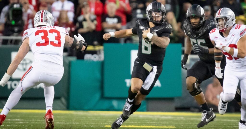 Oregon quarterback Dillon Gabriel carries the ball during a 32-31 win over Ohio State. (Ben Lonergan/The Register-Guard / USA TODAY NETWORK via Imagn Images)