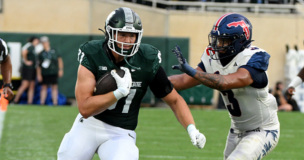 Michigan State Spartans tight end Michael Masunas (81) gets a first down against Florida Atlantic Owls linebacker Eddie Williams (3) in the first quarter at Spartan Stadium. - Dale Young, USA TODAY Sports