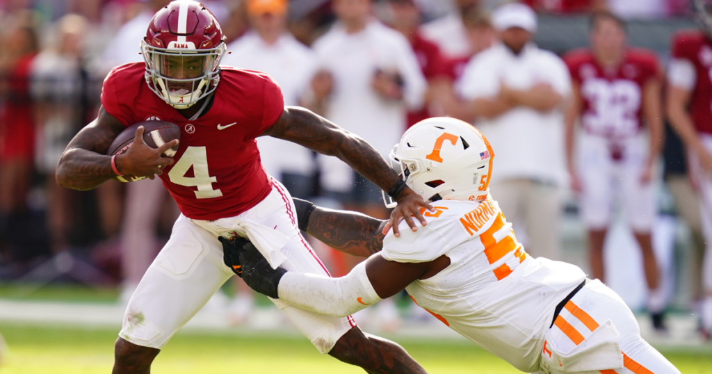 Oct 21, 2023; Tuscaloosa, Alabama, USA; Alabama Crimson Tide quarterback Jalen Milroe (4) gets sacked behind the line of scrimmage by Tennessee Volunteers defensive lineman Omarr Norman-Lott (55) during the first half at Bryant-Denny Stadium. Mandatory Credit: John David Mercer-Imagn Images