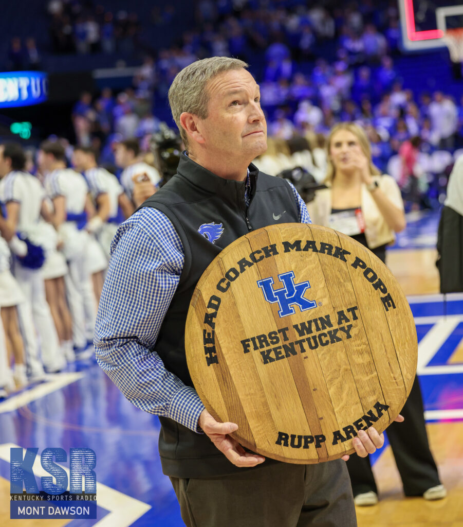 Kentucky athletic director Mitch Barnhart holds a commemorative bourbon barrel top following Mark Pope's first win as head coach - Mont Dawson, Kentucky Sports Radio