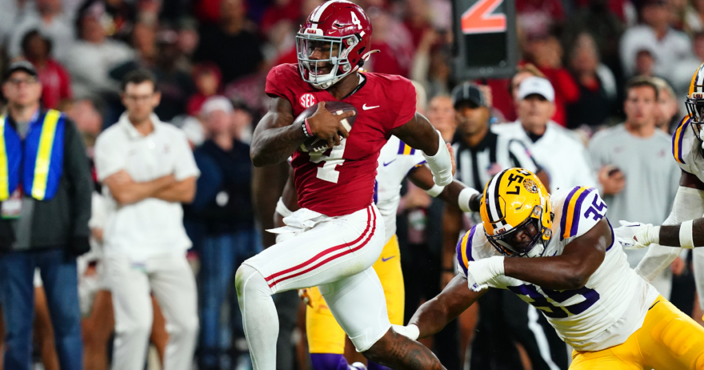 Nov 4, 2023; Tuscaloosa, Alabama, USA; Alabama Crimson Tide quarterback Jalen Milroe (4) scrambles up the field against LSU Tigers defensive end Saivion Jones (35) during the second half at Bryant-Denny Stadium. Alabama Crimson Tide defeated the LSU Tigers 42-28. Mandatory Credit: John David Mercer-Imagn Images