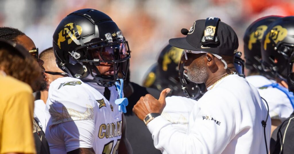 Colorado two-way star Travis Hunter (left) and head coach Deion Sanders (right) talk during a Week 8 win over Arizona. (Mark J. Rebilas-Imagn Images)