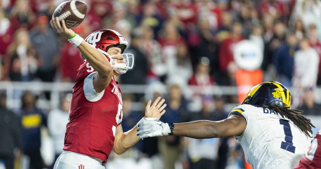 Nov 9, 2024; Bloomington, Indiana, USA; Indiana Hoosiers quarterback Kurtis Rourke (9) passes the ball while Michigan Wolverines linebacker Jaishawn Barham (1) defends in the second half at Memorial Stadium. Mandatory Credit: Trevor Ruszkowski-Imagn Images