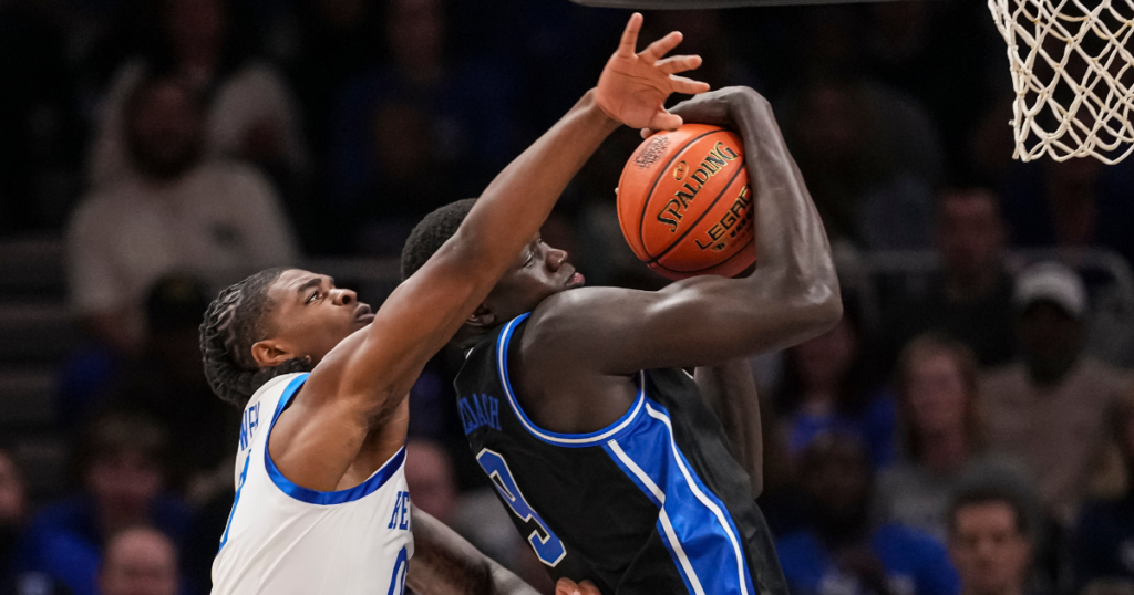 Nov 12, 2024; Atlanta, Georgia, USA; Duke Blue Devils center Khaman Maluach (9) is fouled by Kentucky Wildcats guard Otega Oweh (00) during the first half at State Farm Arena. Mandatory Credit: Dale Zanine-Imagn Images