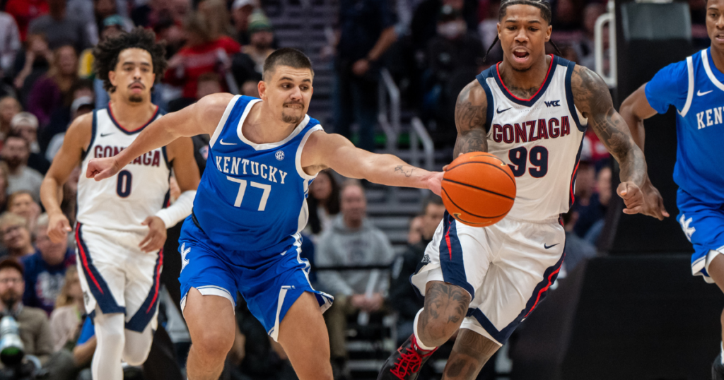 Dec 7, 2024; Seattle, Washington, USA; Kentucky Wildcats guard Kerr Kriisa (77) knocks the ball away from Gonzaga Bulldogs guard Khalif Battle (99) during the first half at Climate Pledge Arena. Mandatory Credit: Stephen Brashear-Imagn Images