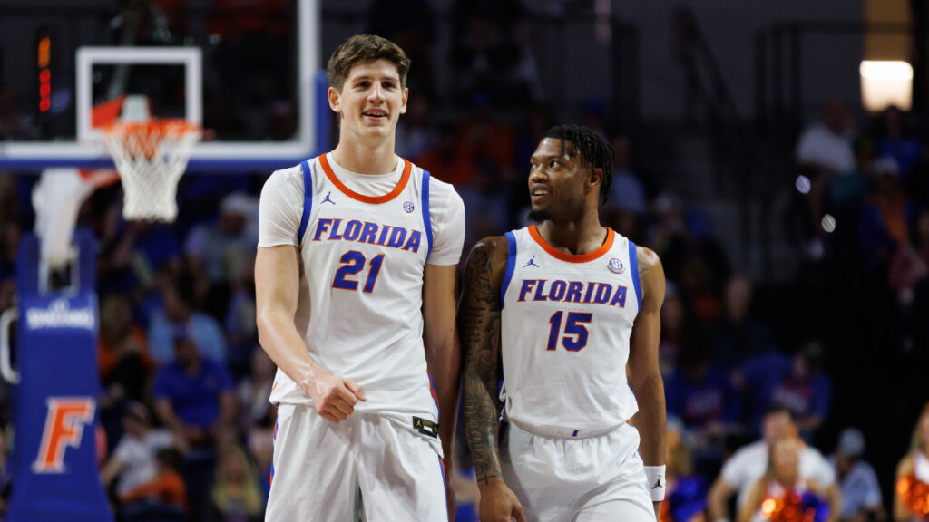 Florida Gators forward Alex Condon (21) and Florida Gators guard Alijah Martin (15) smile while walking to position against the Stetson Hatters during the second half at Exactech Arena at the Stephen C. O'Connell Center. (Matt Pendleton-Imagn Images)