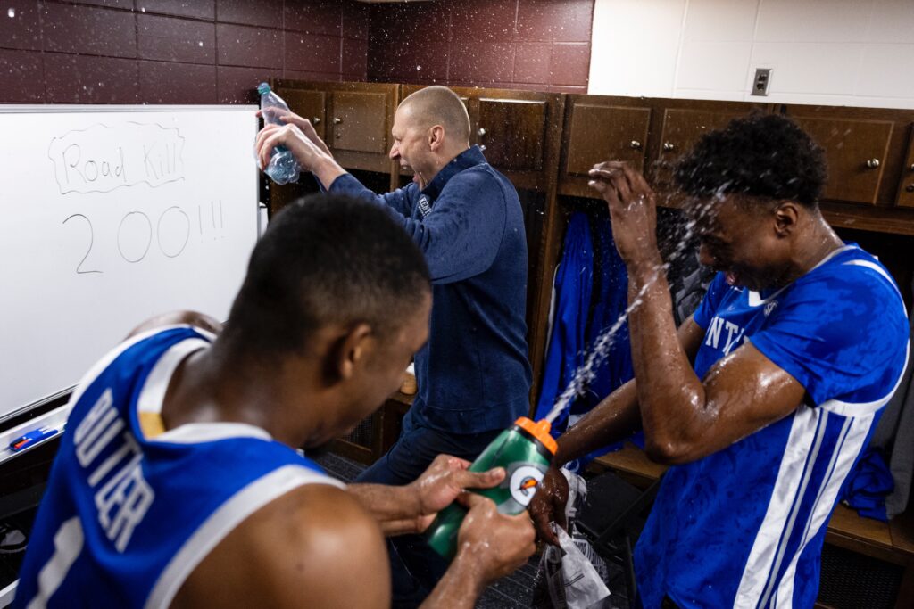 Kentucky players and Mark Pope spray water on Jaxson Robinson after the win at Mississippi State - Chet White, UK Athletics