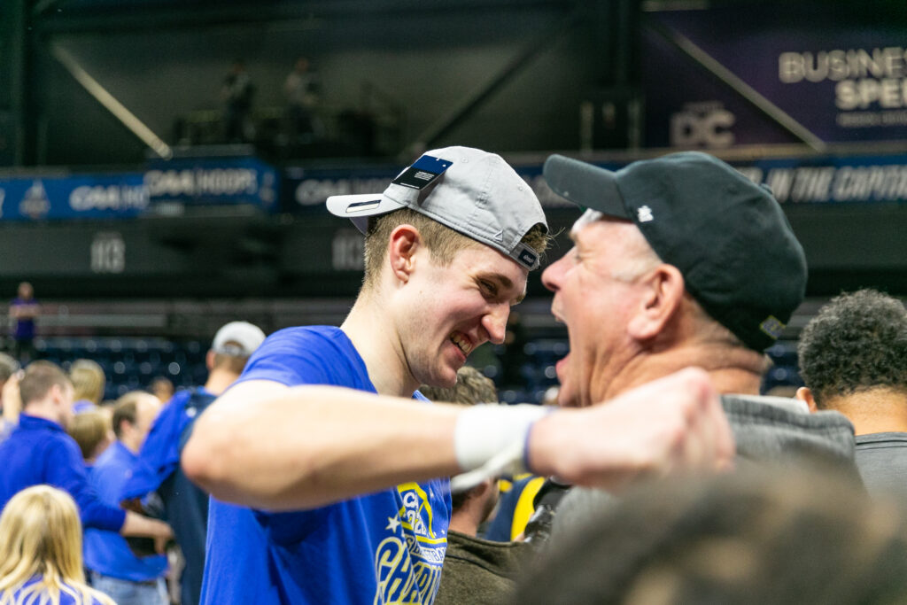 Andrew Carr embraces his dad Phil after winning the CAA Championship with Delaware in 2022 (Photo courtesy of Andrew Carr)