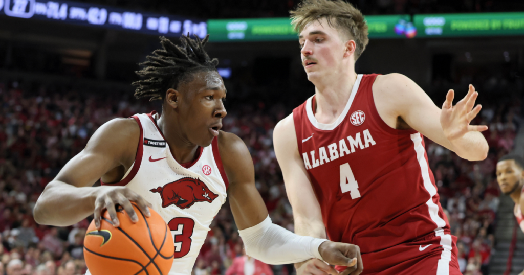 Feb 8, 2025; Fayetteville, Arkansas, USA; Arkansas Razorbacks forward Adou Thiero (3) drives against Alabama Crimson Tide forward Grant Nelson (4) during the first half at Bud Walton Arena. Mandatory Credit: Nelson Chenault-Imagn Images