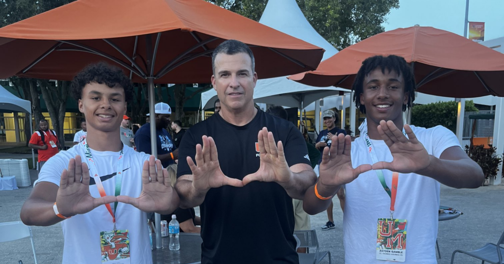 Miami 2027 defensive backs target Jaden Carey (left) with head coach Mario Cristobal and fellow defensive back Zayden Gamble (right)