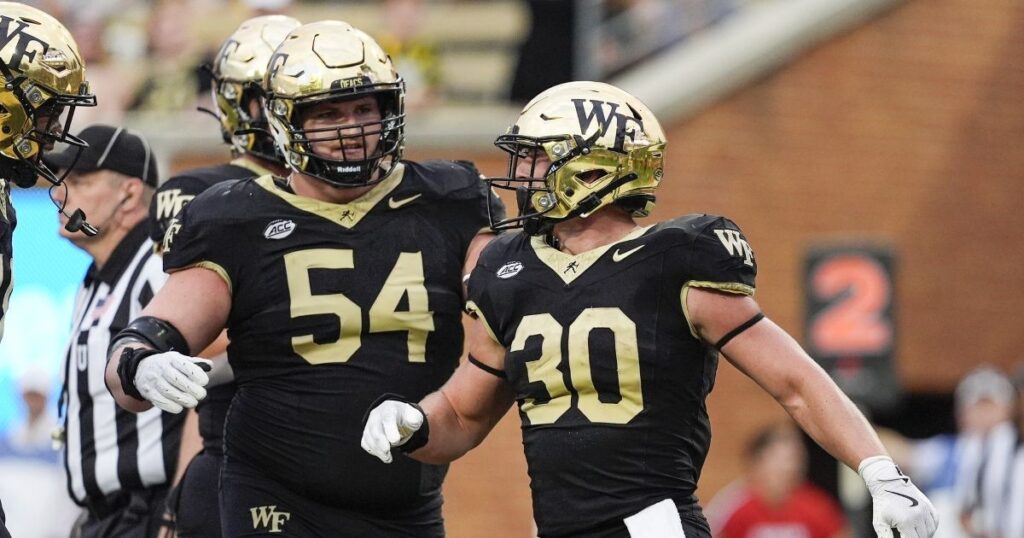 Sep 28, 2024; Winston-Salem, North Carolina, USA; Wake Forest Demon Deacons running back Tate Carney (30) reacts to his game tying touchdown late during the second half with offensive lineman Matt Gulbin (54) against the Louisiana-Lafayette Ragin Cajuns at Allegacy Federal Credit Union Stadium. Mandatory Credit: Jim Dedmon-Imagn Images