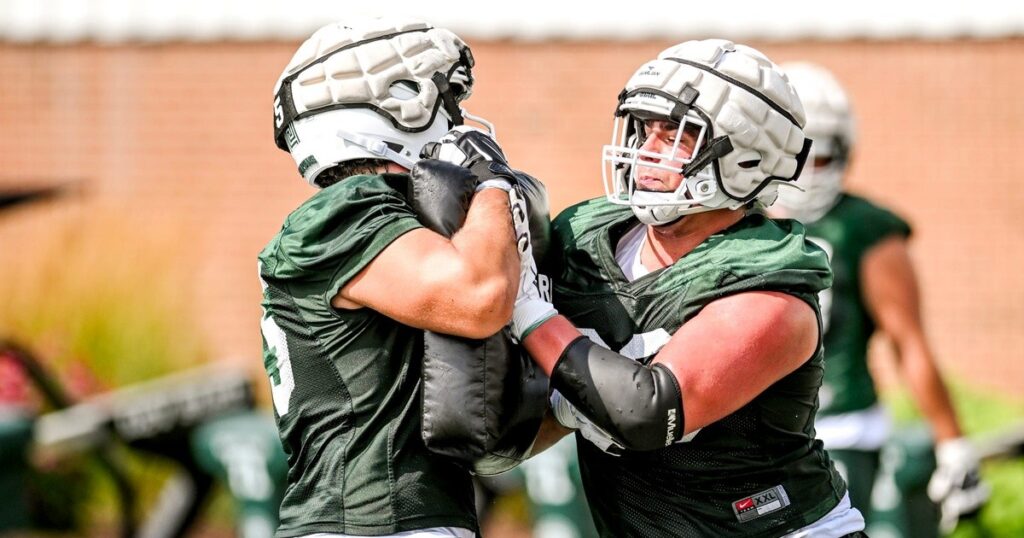Michigan State's Ashton Lepo, right, and Charlton Luniewski run an offensive line drill during the first day of football camp on Tuesday, July 30, 2024, in East Lansing. (© Nick King/Lansing State Journal / USA TODAY NETWORK)