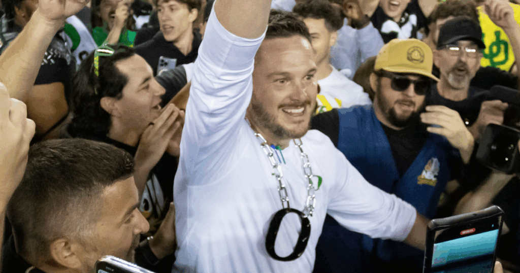 Oregon Ducks head coach Dan Lanning celebrates amid a crowd of fans on the field as the No. 3 Oregon Ducks knock off the No. 2 Ohio State Buckeyes 32-31 Saturday, Oct. 12, 2024 at Autzen Stadium in Eugene, Ore.