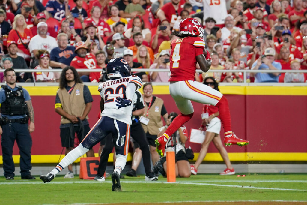 Kansas City Chiefs wide receiver Rashee Rice (4) catches a pass for a touchdown as Chicago Bears cornerback Tyrique Stevenson (29) defends during the first half of the game at GEHA Field at Arrowhead Stadium.