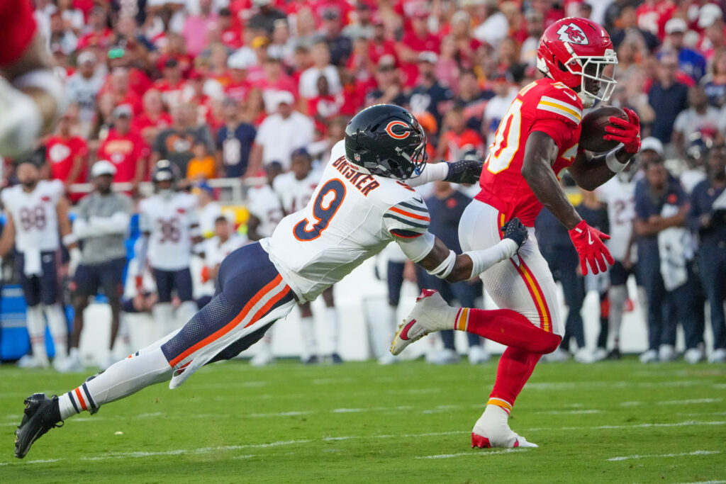 Kansas City Chiefs running back Brashard Smith (30) catches a pass as Chicago Bears safety Jaquan Brisker (9) makes the tackle during the first half of the game at GEHA Field at Arrowhead Stadium.