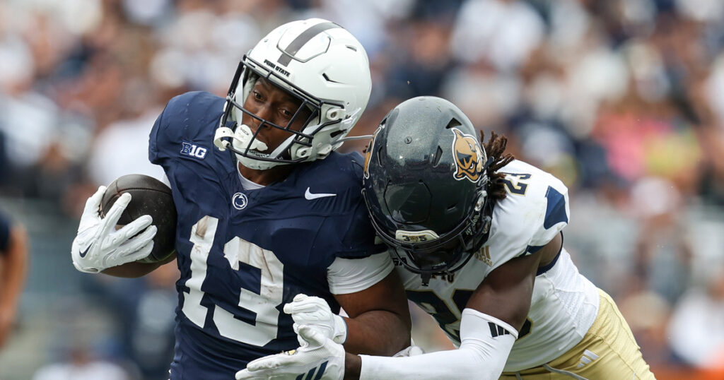 Penn State Nittany Lions running back Kaytron Allen (13) runs with the ball before being pushed out of bounds by Florida International Panthers defensive back Jessiah McGrew (23) during the first quarter at Beaver Stadium. Mandatory Credit: Matthew O'Haren-Imagn Images