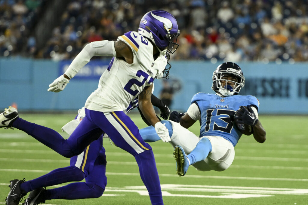 Aug 22, 2025; Nashville, Tennessee, USA; Tennessee Titans wide receiver James Proche II (13) takes a hit against the Minnesota Vikings during the second half at Nissan Stadium. Mandatory Credit: Steve Roberts-Imagn Images